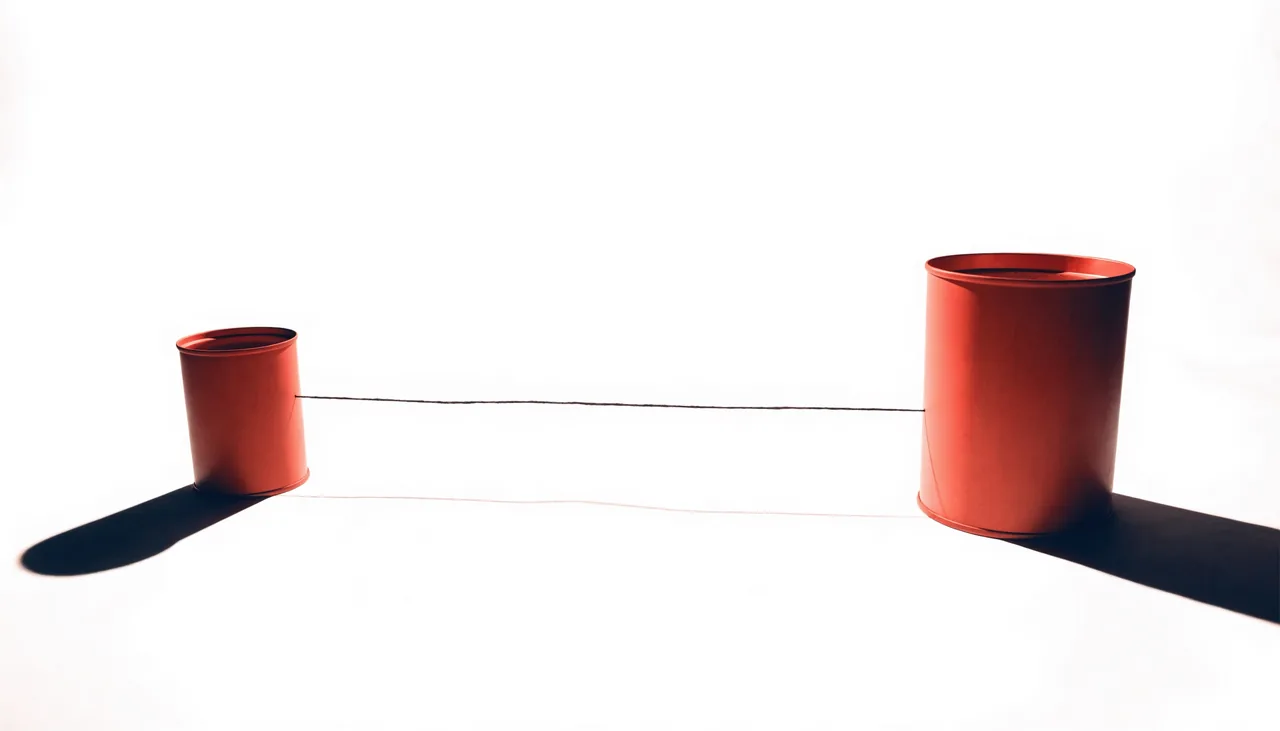Conceptual still life showing two sides connected by a taut line.